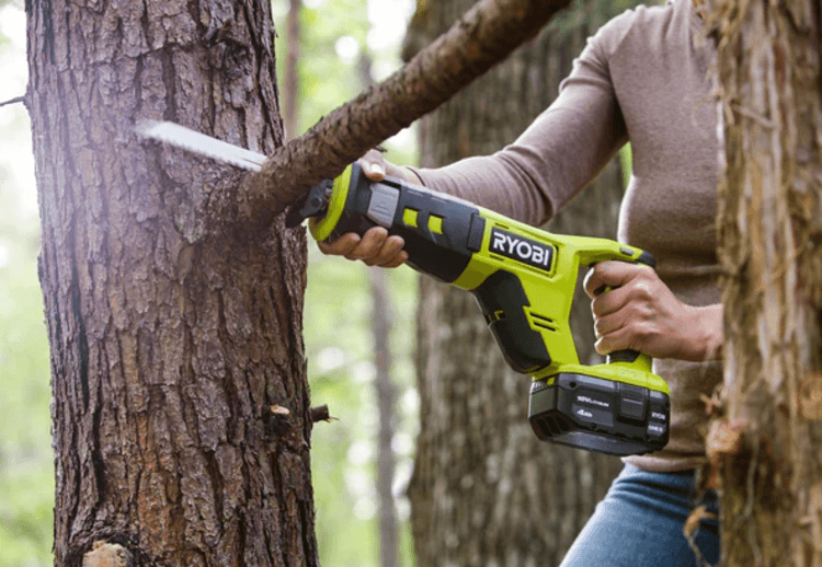 Using the Ryobi P515 for pruning a tree in the forest
